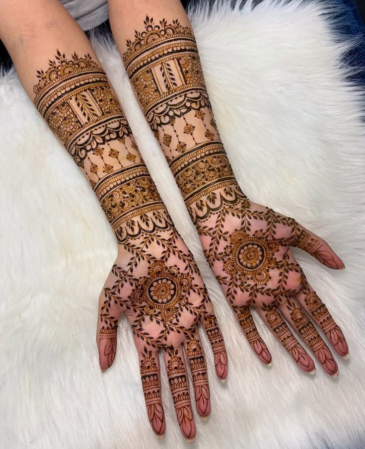 This may contain: two hands with henna designs on them