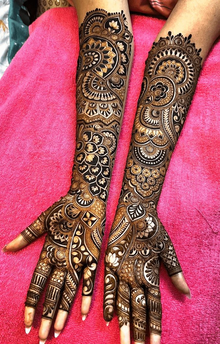 This may contain: two hands with henna tattoos on them