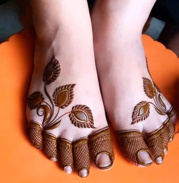 This may contain: the feet are decorated with flowers and leaves