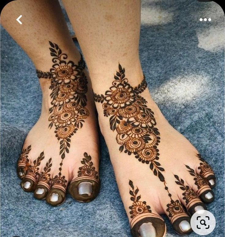 This may contain: the feet are decorated with henna and beads