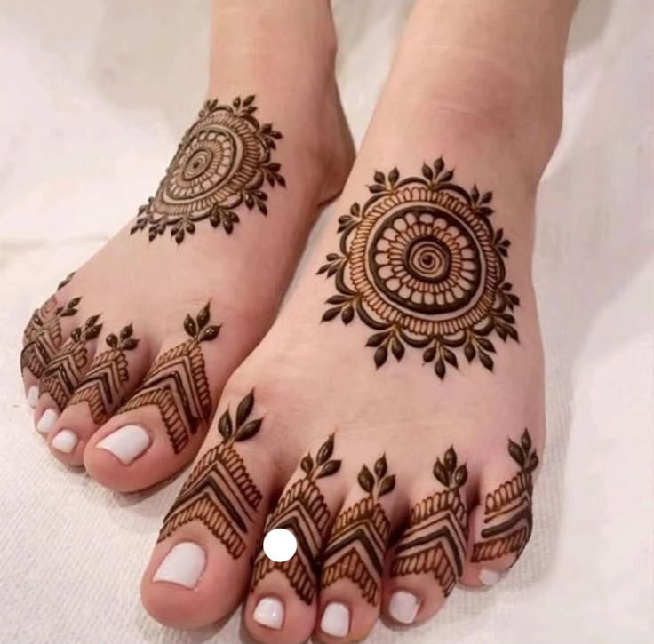 This may contain: the feet are decorated with henna designs