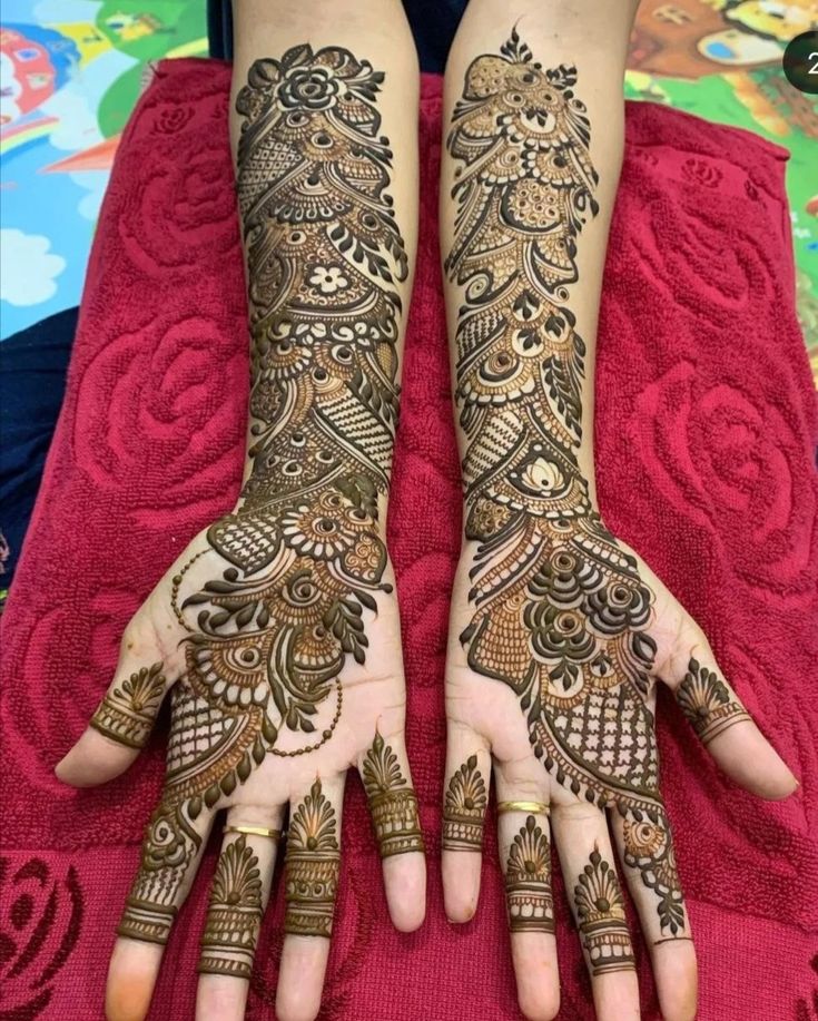 This may contain: two hands with henna tattoos on them