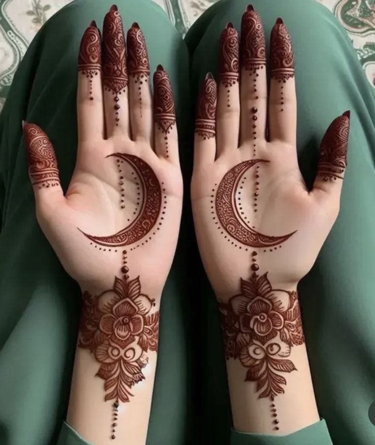 This may contain: two hands with henna tattoos on them