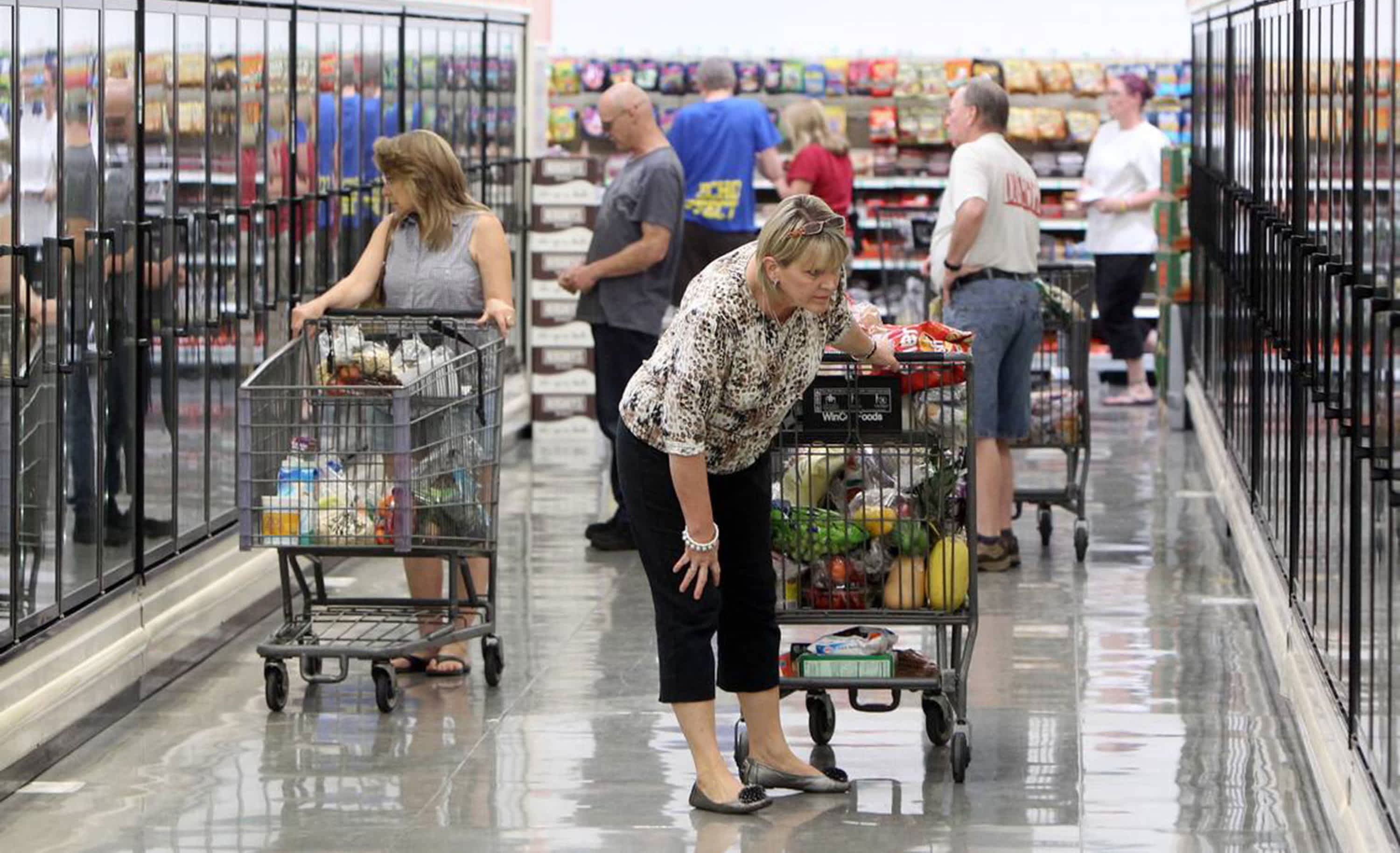 Shoppers browse the frozen food cases at WinCo. (Joe Jaszewski/Idaho Statesman/Tribune News Service via Getty Images)