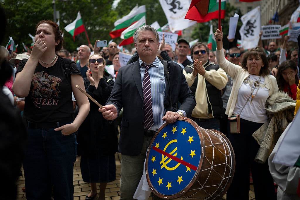 A person beats a drum with the euro logo crossed out in red on the drumhead during a demonstration against Bulgaria entering the Eurozone in Sofia on May 31, 2025.