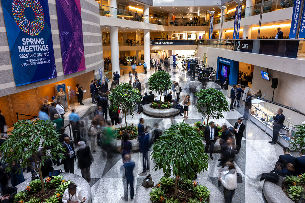 Guests and attendeess mingle and walk through the atrium during the IMF/World Bank Group Spring Meetings at the IMF headquarters in Washington, DC, on April 24, 2025. On April 23, US Secretary of Treasury Scott Bessent said that while the IMF and World Bank serve critical roles in the global economy, "under the status quo, they are falling short." He added that they "must step back from their sprawling and unfocused agendas." (Photo by Jim WATSON / AFP) (Photo by JIM WATSON/AFP via Getty Images)          